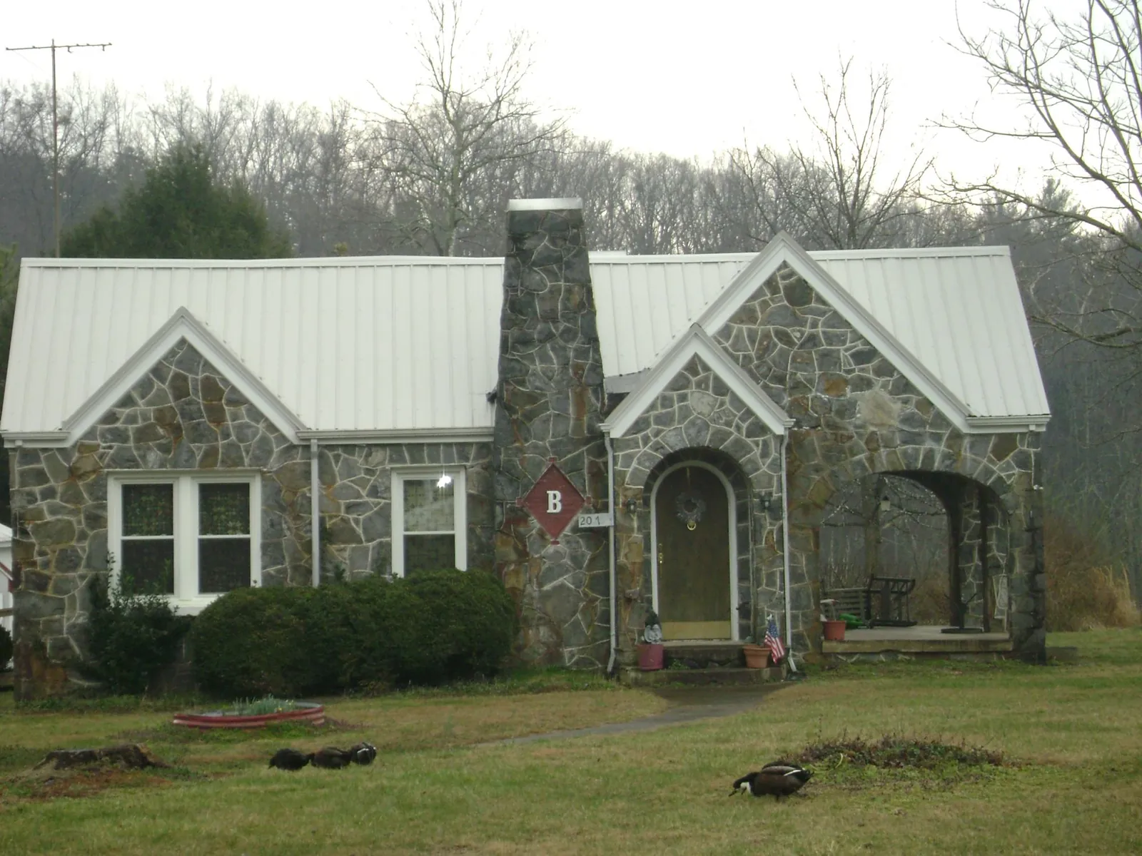 White metal roof on a stone cottage with steep gables in Kimberly